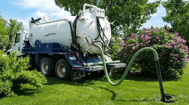 Professional vacuum truck performing residential drainage and septic maintenance in Birmingham, AL