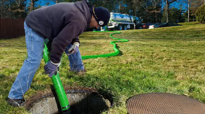 Service technician performing residential septic pumping and drainage maintenance in Birmingham, AL